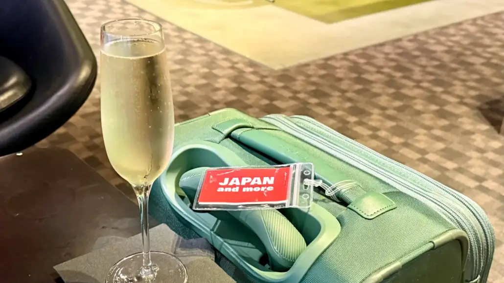 Insurance in Japan with a Suitcase and Champagne Glass