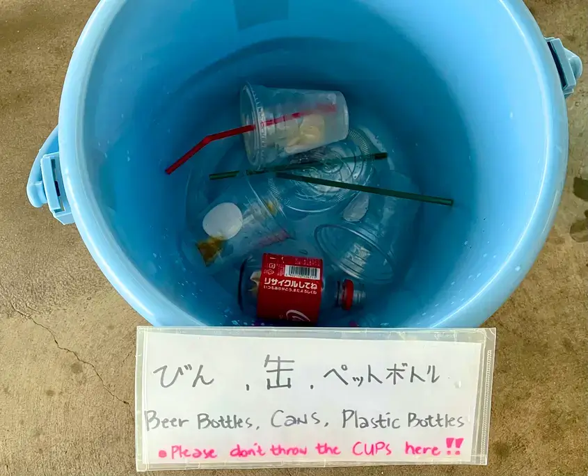 Sign on trash can asking customers to not throw cups away in the bin