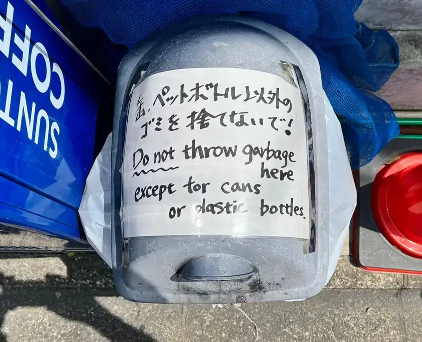 Recycle bin next to a vending machine
