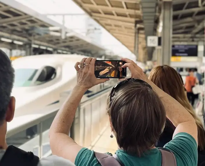 Tour Guest Taking Photo of Shinkansen